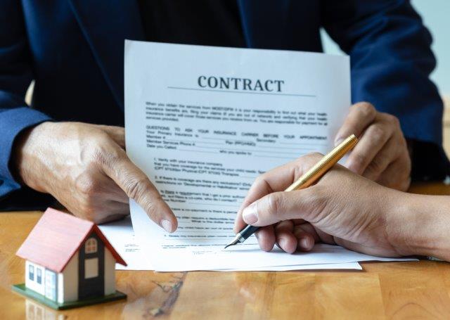 Signing a contract to buy a home